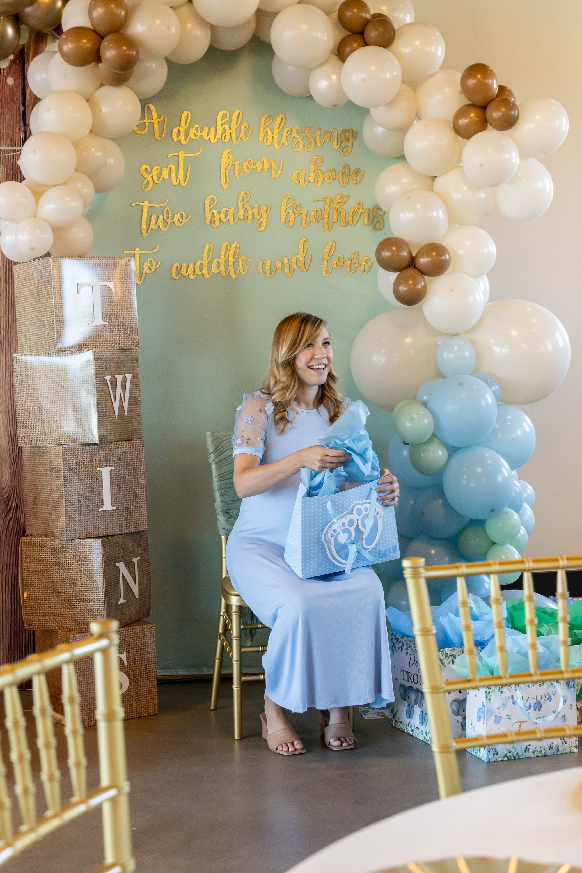 Guest of honour opening gifts at a twin baby shower at The Chestnut Hall