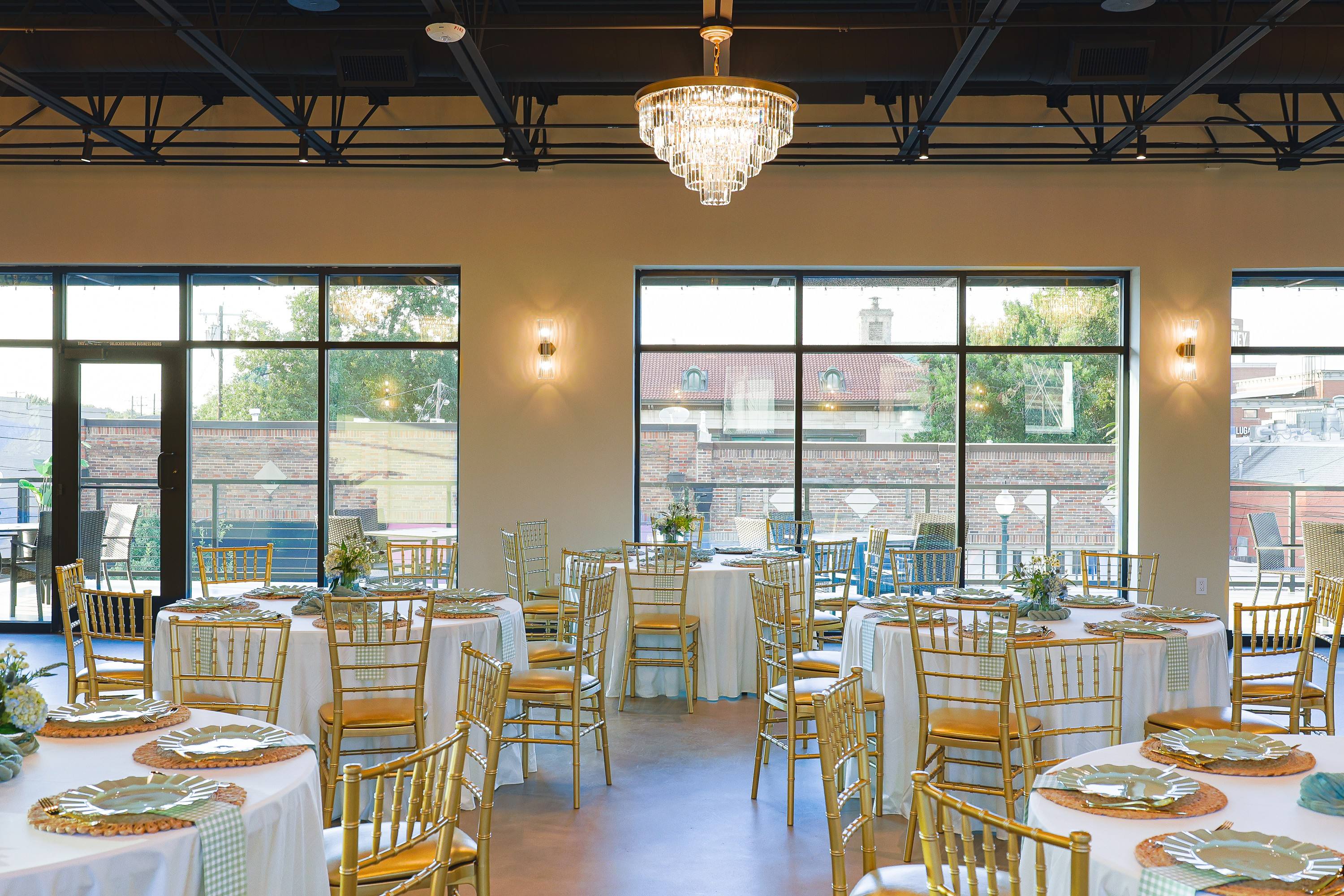 Round tables set for a baby shower beside the windows at The Chestnut Hall